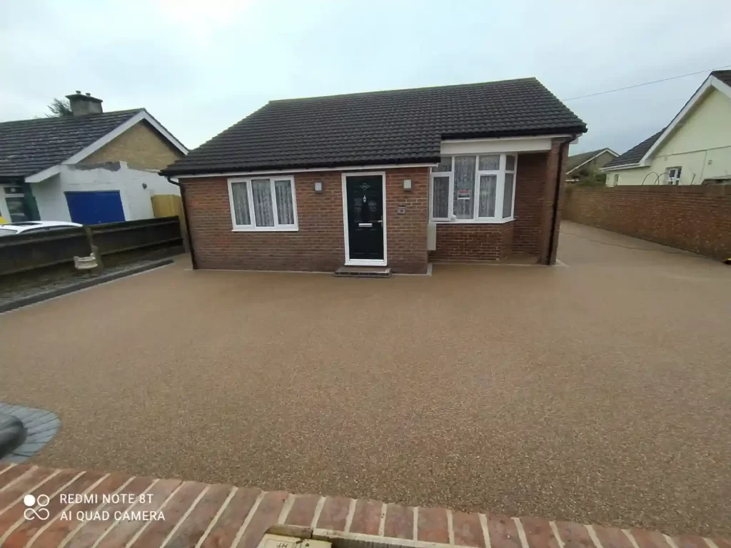 Large yellow resin driveway surrounding house