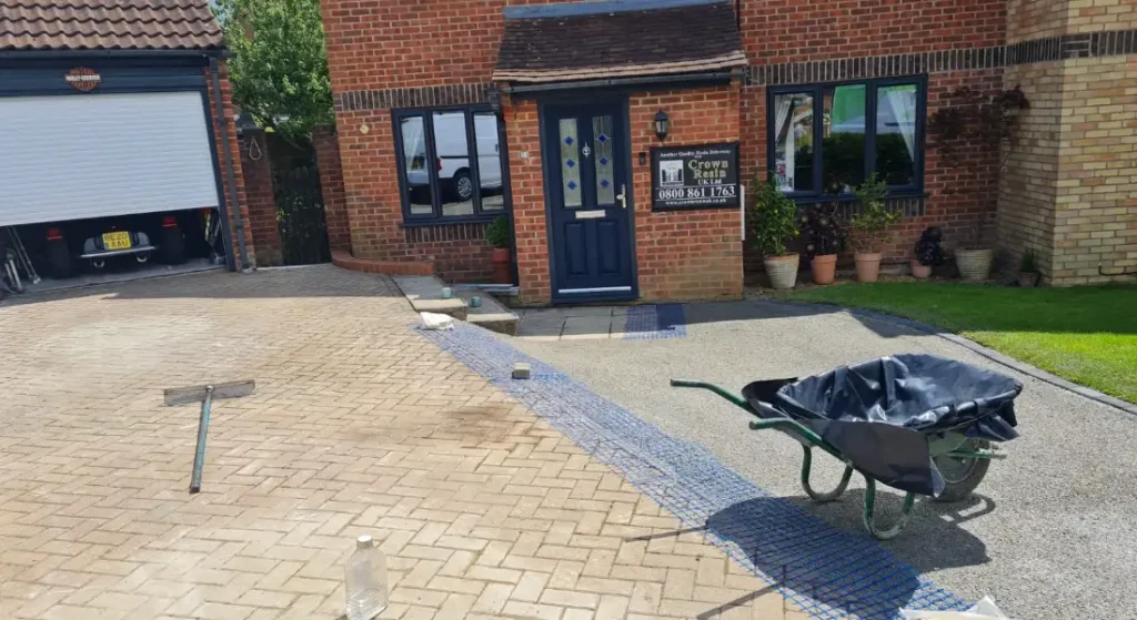 Crack-resistant membrane between the patio and sub-base and the remaining brick driveway and the sub-base
