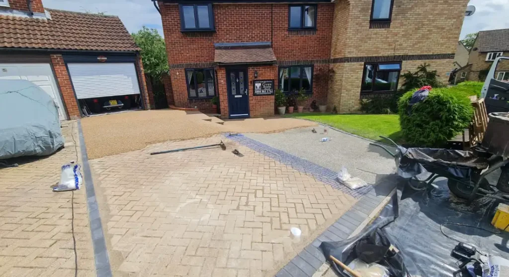 Laying the aggregate stone and resin down the driveway